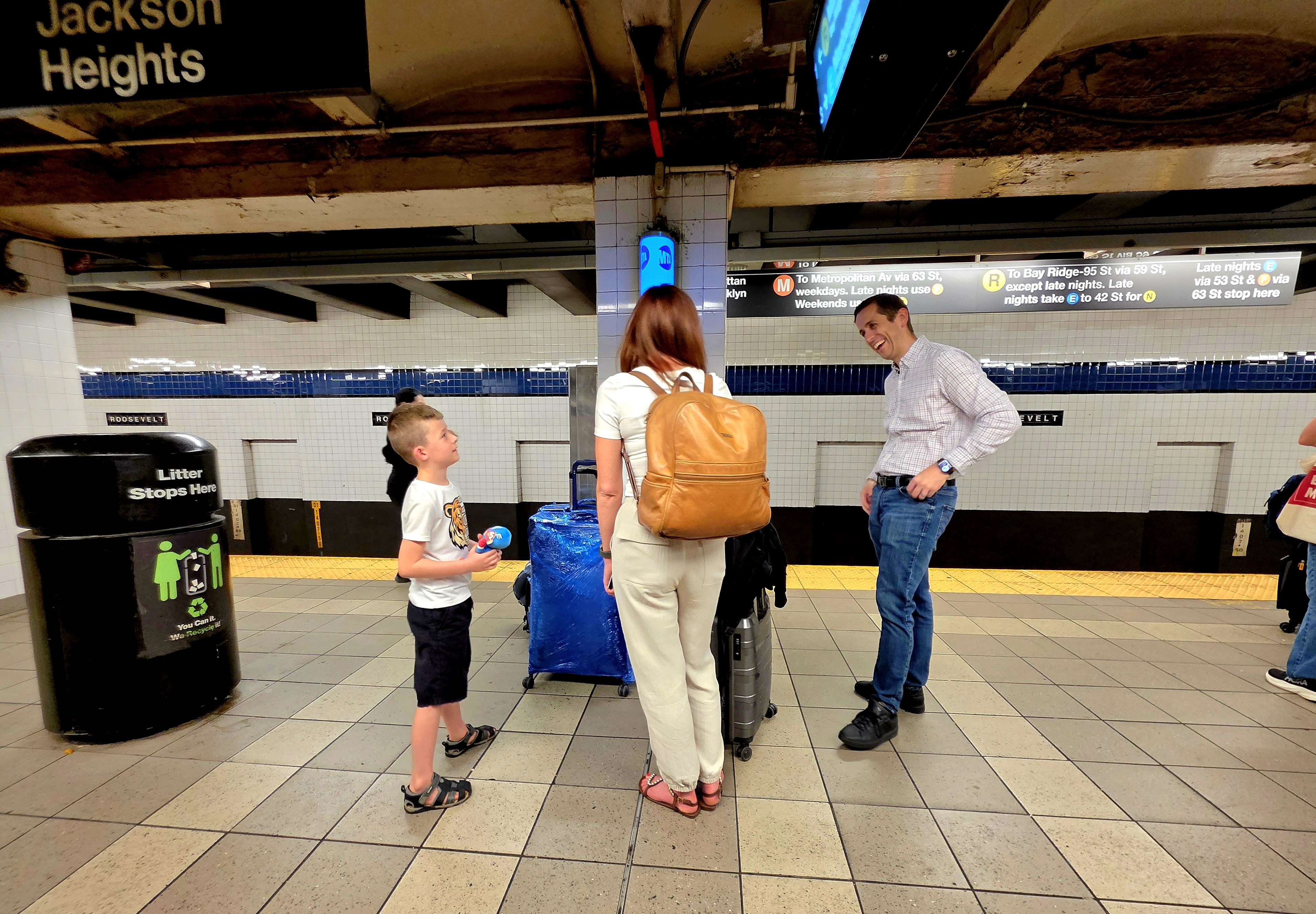 Family members waiting with luggage at the Roosevelt Island subway station.