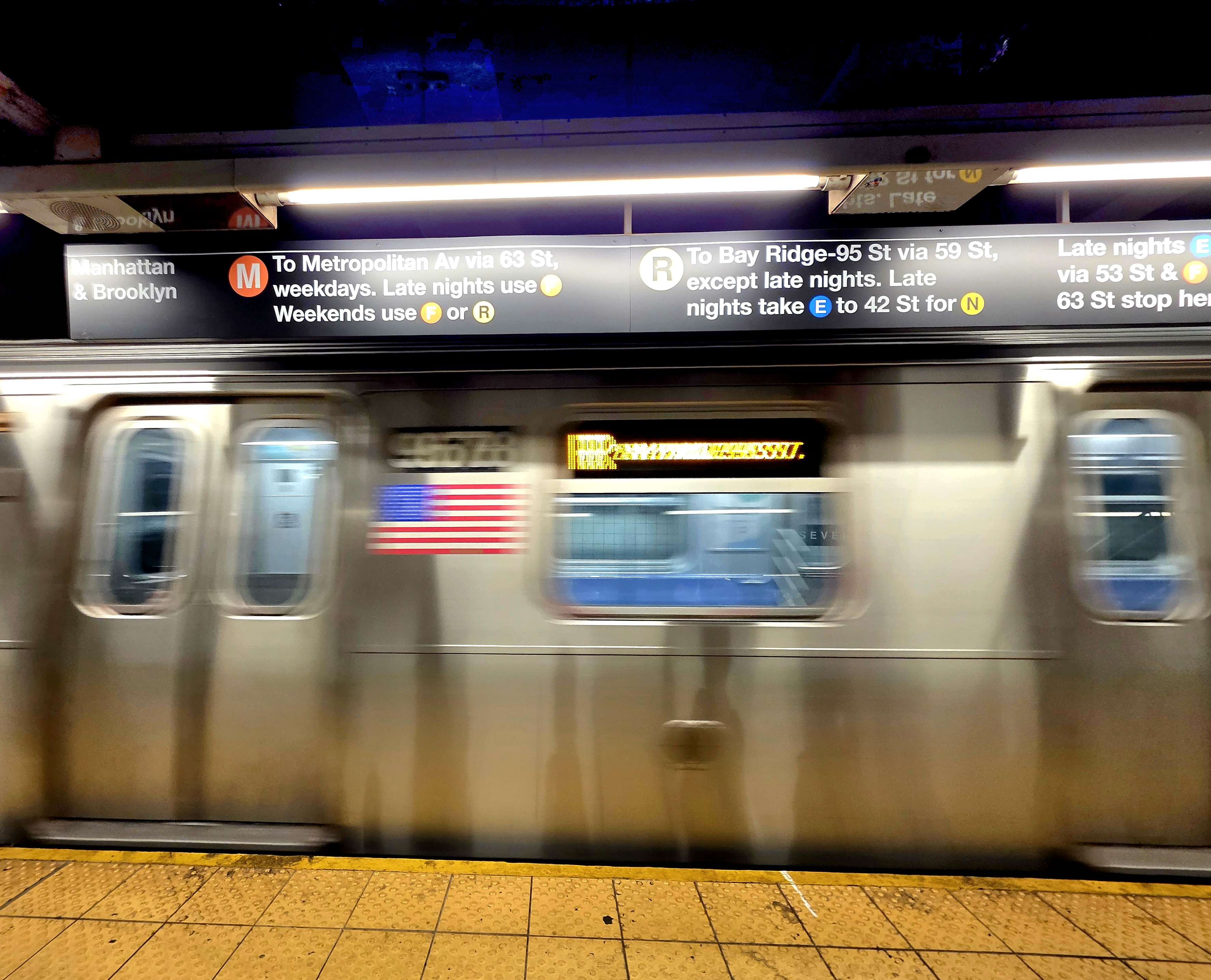A New York subway train passing the Roosevelt Island platform.